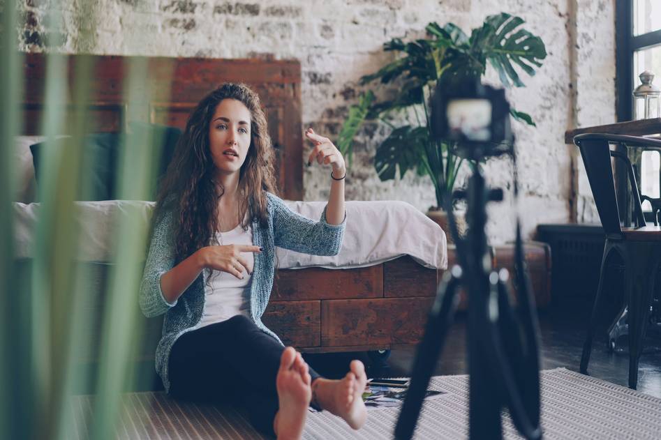 Makeup influencer applying blush in soft natural light