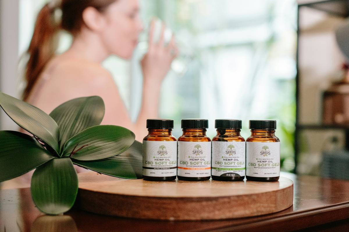 makeup influencer in beauty makeup supplements wellness group reviewing supplement bottles and skin health data